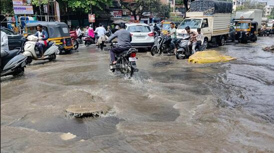 Drainage water overflows near Dolphin Chowk in Pune on Tuesday. (Rahul Raut/HT PHOTO)