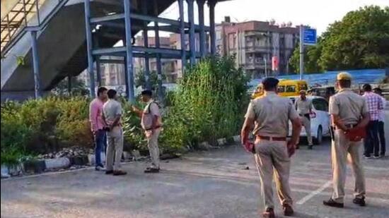 Police at the crime scene near Iffco Chowk in Gurugram. (HT Photo)