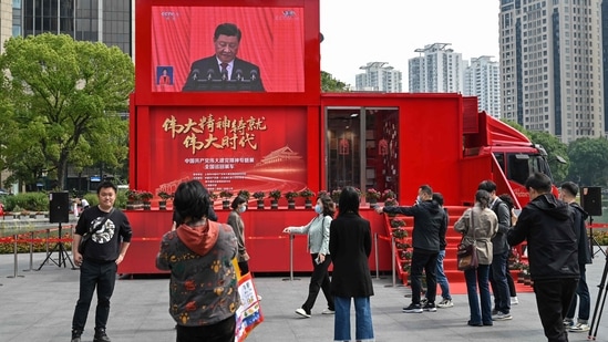 People watch a screen showing China's President Xi Jinping speaking during the opening session of the Chinese Communist Party's Congress in Shanghai. (AFP) People watch a screen showing China's President Xi Jinping speaking during the opening session of the Chinese Communist Party's Congress in Shanghai. (AFP)
