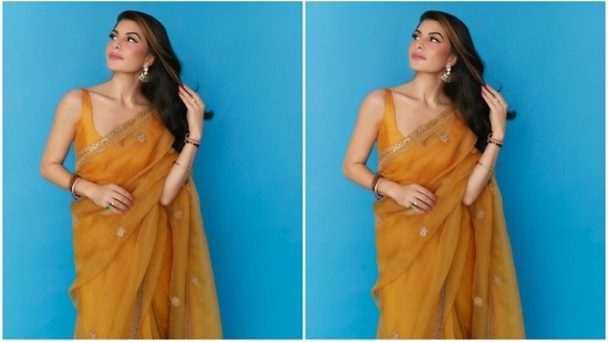 Jacqueline paired the drape with a matching yellow silk blouse featuring a wide U neckline, plunging back, broad straps, and back hook closures.(Instagram)