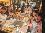 Ram Charan and Upasana with fans at a restaurant in Japan.