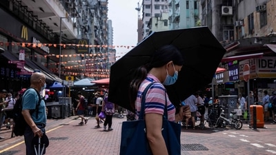 Hong Kong: A woman uses an umbrella to shield herself from the sun in Hong Kong. (AFP) Hong Kong: A woman uses an umbrella to shield herself from the sun in Hong Kong. (AFP)
