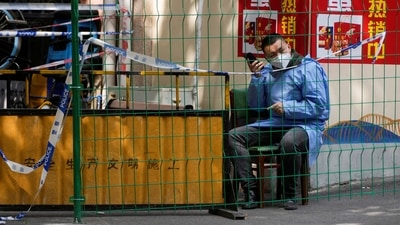Covid In Shanghai: A worker in a protective suit in Shanghai, China. (Reuters)