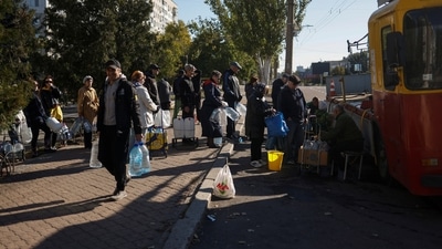 Russia-Ukraine War: Local people queue to fill up bottles with fresh drinking water in Kherson region. (Reuters)