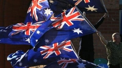 A file photo of a man waving Australian flags. (AP Photo) A file photo of a man waving Australian flags. (AP Photo)