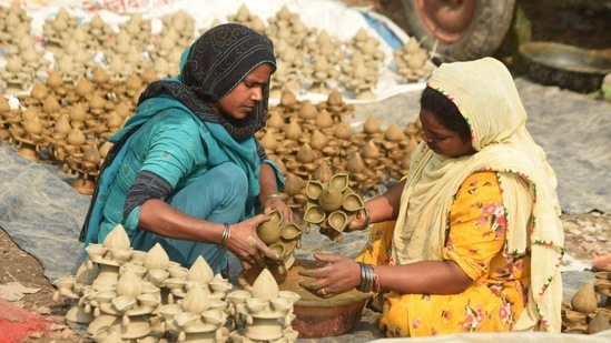 Women in Lucknow seen making earthen diyas of various designs for Diwali decorations. (Deepak Gupta/ HT Photo)