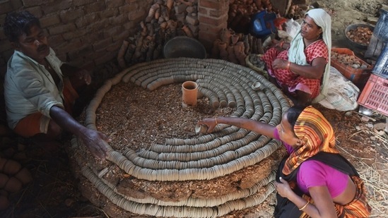 A Muslim potter family also takes part in making earthen lamps at their home workshop ahead of the Diwali festival at Chinhat in Lucknow. (Deepak Gupta/ HT Photo)