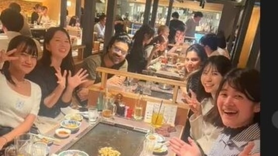 Ram Charan and Upasana with fans at a restaurant in Japan.