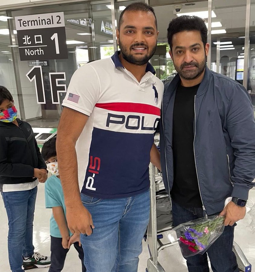 Jr NTR poses with a fan in Japan as his son looks on. Jr NTR poses with a fan in Japan as his son looks on. 