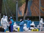 World Health Organization On Covid Pandemic: Health workers and staff wear protective suits inside a residential compound in Beijing.