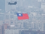 US-Taiwan Relations: A Chinook helicopter carrying a Taiwan flag flies over the city during the country's National Day celebration in Taipei, Taiwan.