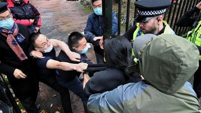 In this Handout provided by Matthew Leung, Hong Kong protester Bob Chan scuffles with people who are trying to drag him into the Chinese consulate in Manchester, England, on Sunday. Chan said he and others were holding a peaceful anti-government protest outside the consulate on Sunday when masked men came out, tore down the protesters’ banners and dragged him inside the buildings gates. (AP) In this Handout provided by Matthew Leung, Hong Kong protester Bob Chan scuffles with people who are trying to drag him into the Chinese consulate in Manchester, England, on Sunday. Chan said he and others were holding a peaceful anti-government protest outside the consulate on Sunday when masked men came out, tore down the protesters’ banners and dragged him inside the buildings gates. (AP)