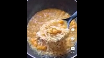 The image, taken from the Reddit video, shows an individual cooking Cheese Cheetos Maggi. (Screengrab)
