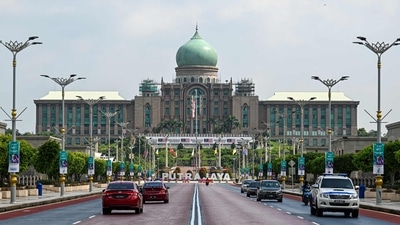 Malaysia Elections Motorists drive on a road in front of the office complex of the Malaysian prime minister in Putrajaya. (AFP)
