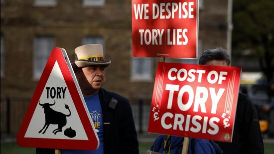 Demonstrators protest opposite parliament after Britain's Prime Minister Liz Truss resigned in London, on Thursday. (AP)