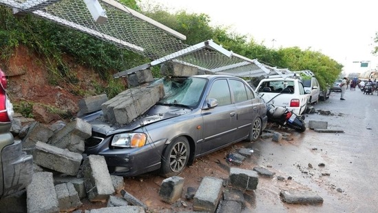 Damaged cars after the retaining wall of Bengaluru Metro Rail Corporation Limited collapsed due to heavy rainfall. (PTI)
