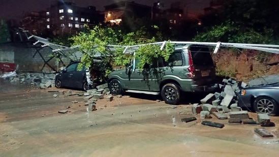 Several vehicles were damaged after a wall collapsed due to torrential rains, near Majestic, in Bengaluru.(ANI)