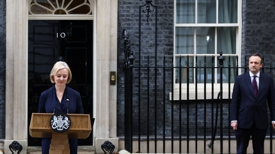 British Prime Minister Liz Truss announces her resignation, as her husband Hugh O'Leary stands nearby, outside Number 10 Downing Street, London.(REUTERS)