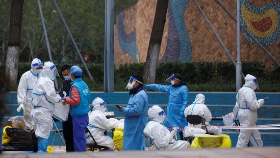 World Health Organization On Covid Pandemic: Health workers and staff wear protective suits inside a residential compound in Beijing.(Reuters)