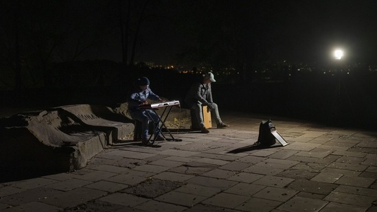 Sakharov Prize 2022: Street musicians play their instruments in a square without electric lights in Kyiv, Ukraine.(AP)