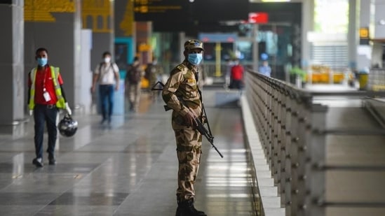 A CISF personnel wears a face mask as he stand guards, at IGI Airport.(Amal KS/HT Photo/For Representative Purposes Only)