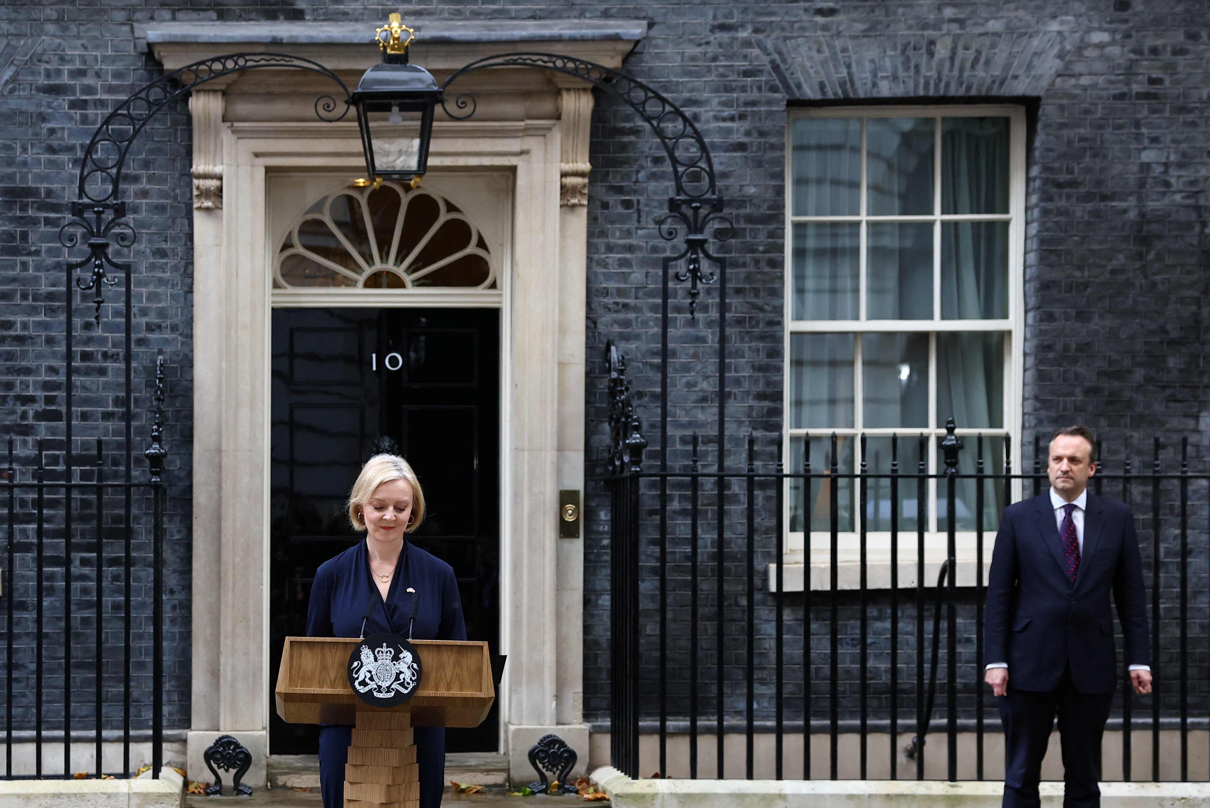British Prime Minister Liz Truss announces her resignation, as her husband Hugh O'Leary stands nearby, outside Number 10 Downing Street, London. (REUTERS)