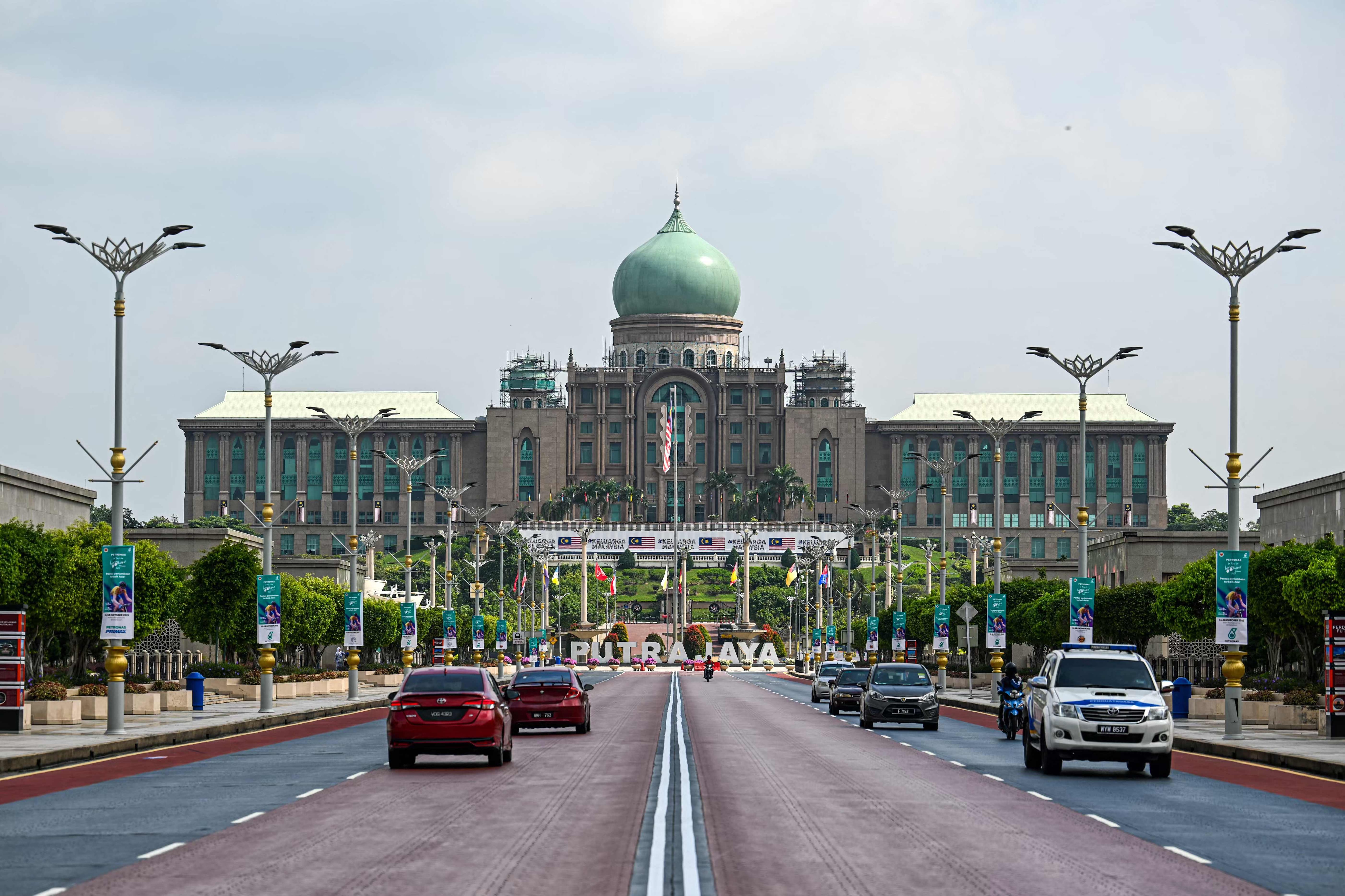 Malaysia Elections Motorists drive on a road in front of the office complex of the Malaysian prime minister in Putrajaya. (AFP) Malaysia Elections Motorists drive on a road in front of the office complex of the Malaysian prime minister in Putrajaya. (AFP)