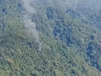 Smoke billows from site where military helicopter crashed in Upper Siang district of Arunachal Pradesh on Friday.