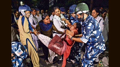 Security personnel detain Teacher Eligibility Test (TET) 2014 qualified candidates from their sit-in protest demanding primary school teachers' jobs on Friday. (PTI) Security personnel detain Teacher Eligibility Test (TET) 2014 qualified candidates from their sit-in protest demanding primary school teachers' jobs on Friday. (PTI)