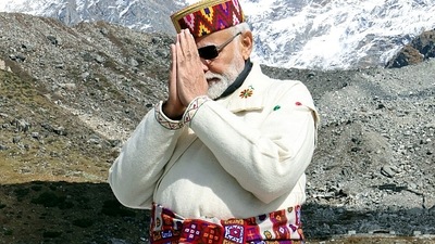PM Modi wore the white traditional attire of the hill people with a swastika embroidered on it. (ANI/ PIB) PM Modi wore the white traditional attire of the hill people with a swastika embroidered on it. (ANI/ PIB)