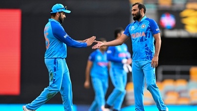 Indian captain Rohit Sharma, left, gestures to teammate Mohammed Shami following the ICC T20 World Cup warm-up cricket match between Australia and India at the Gabba (AP) Indian captain Rohit Sharma, left, gestures to teammate Mohammed Shami following the ICC T20 World Cup warm-up cricket match between Australia and India at the Gabba (AP)