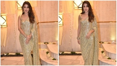 Rhea Chakraborty was spotted wearing a dazzling golden saree with minimal jewellery. (HT Photo/Naziyah Khan) Rhea Chakraborty was spotted wearing a dazzling golden saree with minimal jewellery. (HT Photo/Naziyah Khan)