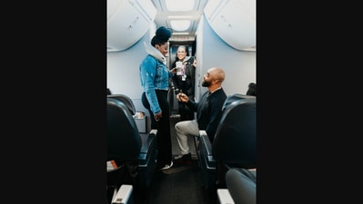 The image, taken from a Facebook post by United Airlines, shows the man proposing to his girlfriend inside a plane. (Facebook/@United)