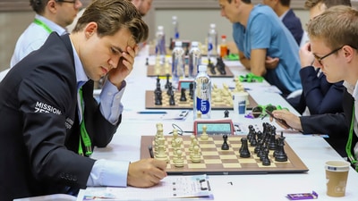 Chess World Champion Magnus Carlsen (L) during round 10 of the 44th Chess Olympiad, at Mamallapuram near Chennai (PTI) Chess World Champion Magnus Carlsen (L) during round 10 of the 44th Chess Olympiad, at Mamallapuram near Chennai (PTI)