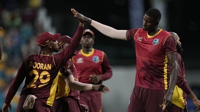 West Indies' captain Nicholas Pooran celebrates with teammate Jason Holder (AP)