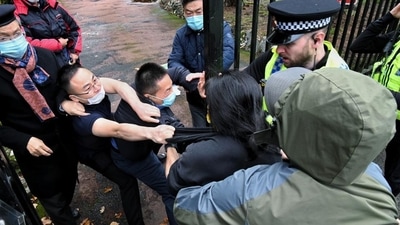 In this Handout provided by Matthew Leung, Hong Kong protester Bob Chan scuffles with people who are trying to drag him into the Chinese consulate in Manchester, England, on Sunday. (AP)