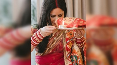 Katrina Kaif wore a beautiful red saree with a contrasting pastel green blouse while Vicky Kaushal complemented his wife in a beige kurta pyjama. (Instagram/@katrinakaif)