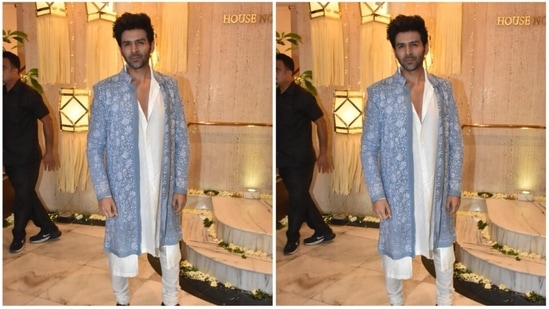 Kartik Aaryan looked dapper in his white kurta set which he paired with a blue ethnic jacket.(HT Photo/Naziyah Khan)