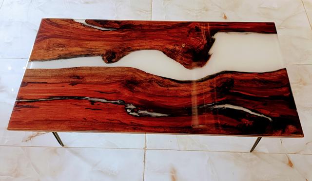 This rich and artistic coffee table is made with a hundred year old Mahogany wood piece, soaked and then coated in resin. (Wood & metal coffee table by Cinnamon Homes This rich and artistic coffee table is made with a hundred year old Mahogany wood piece, soaked and then coated in resin. (Wood & metal coffee table by Cinnamon Homes