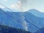 Smoke comes out from the site of the helicopter crash in the Upper Siang district of Arunachal Pradesh on Friday. (ANI Photo) Smoke comes out from the site of the helicopter crash in the Upper Siang district of Arunachal Pradesh on Friday. (ANI Photo)