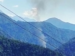 Smoke comes out from the site of the helicopter crash in the Upper Siang district of Arunachal Pradesh on Friday. (ANI)