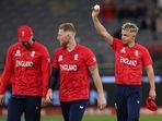 England bowler Sam Curran holds the ball aloft as he gestures to the crowd 