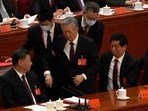 China's Xi Jinping: Former Chinese President Hu Jintao, center, is helped during the closing ceremony. China's Xi Jinping: Former Chinese President Hu Jintao, center, is helped during the closing ceremony.