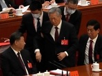 Former Chinese president Hu Jintao, center, is escorted out of the closing ceremony of a congress of the ruling Communist Party on Saturday.(AP) Former Chinese president Hu Jintao, center, is escorted out of the closing ceremony of a congress of the ruling Communist Party on Saturday.(AP)