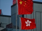 Hong Kong and China flags fly in Hong Kong.