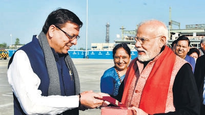 Uttarakhand chief minister Pushkar Singh Dhami on Saturday gifted Almora’s famous ‘Bal Mithai’ and ‘Pahadi Topi’ engraved with state’s official flower, Brahma-Kamal, on it to Prime Minister Narendra Modi at Jolly Grant airport in Dehradun. Modi visited Badrinath and Kedarnath shrines during his two day trip to Uttarakhand that concluded on Saturday. (HT Photo)