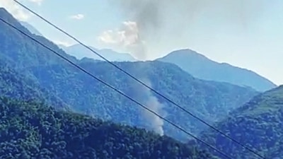 Smoke comes out from the site of the helicopter crash in the Upper Siang district of Arunachal Pradesh on Friday. (ANI) (HT_PRINT)