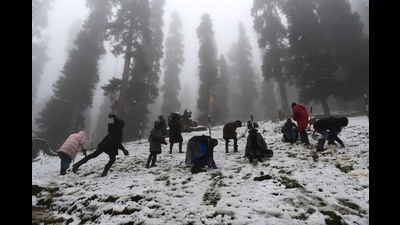 Tourists play with fresh snow in Gulmarg on Thursday. (HT FILE)