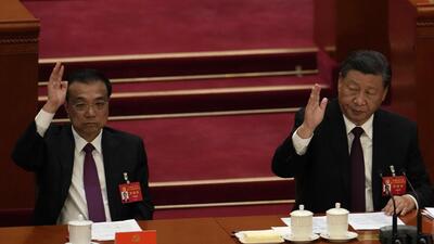 President Xi Jinping (right) looks over as Premier Li Keqiang raises his hand to vote at the closing ceremony of the 20th National Congress of China’s ruling Communist Party at the Great Hall of the People in Beijing, on Saturday. (AP) President Xi Jinping (right) looks over as Premier Li Keqiang raises his hand to vote at the closing ceremony of the 20th National Congress of China’s ruling Communist Party at the Great Hall of the People in Beijing, on Saturday. (AP)
