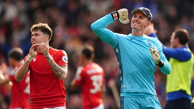 Nottingham Forest's Neco Williams, left, and Nottingham Forest goalkeeper Dean Henderson celebrate after the Premier League match between Nottingham Forest and Liverpool, at the City Ground, in Nottingham. (AP)